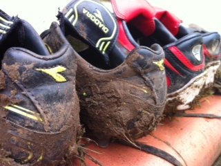 Muddy football boots